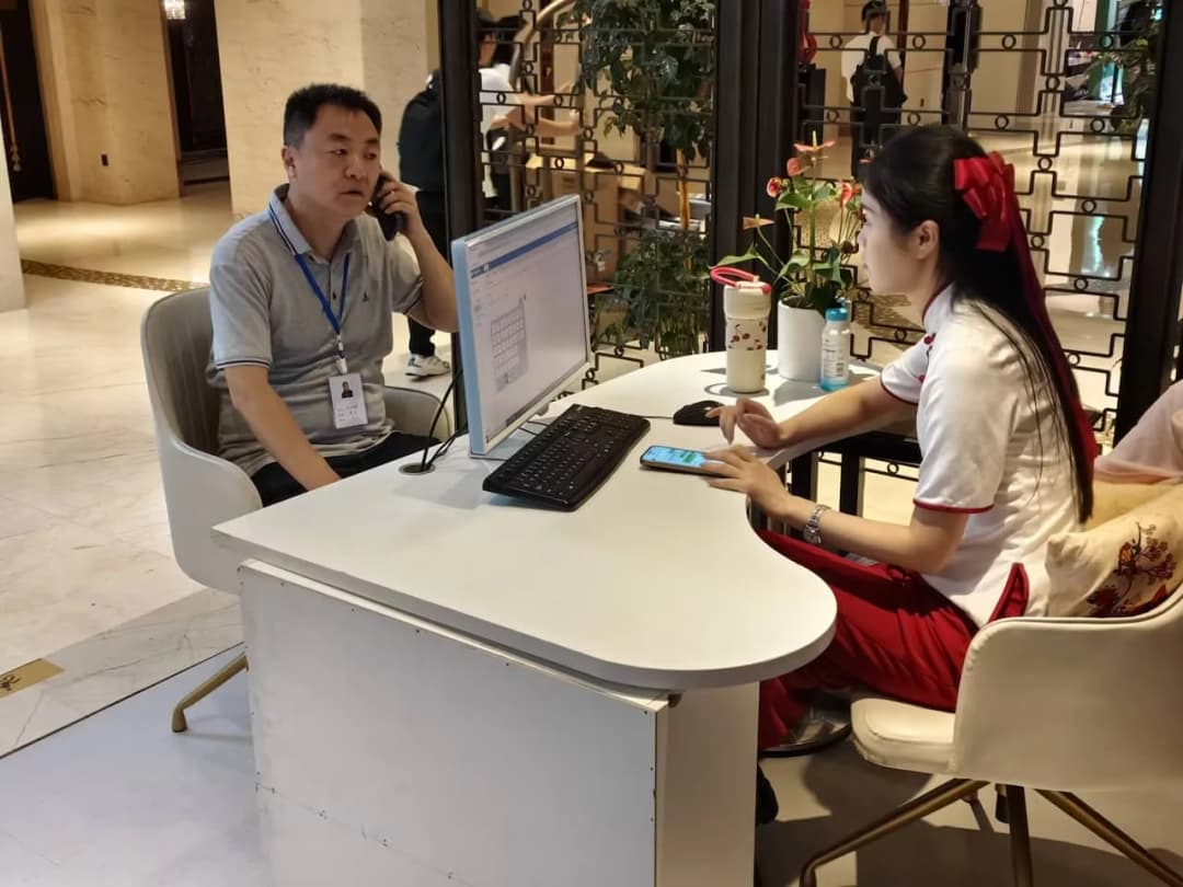 美步科技工程师与 2026 四川系统集成行业千人峰会主办方工作人员在电脑前登记参展信息